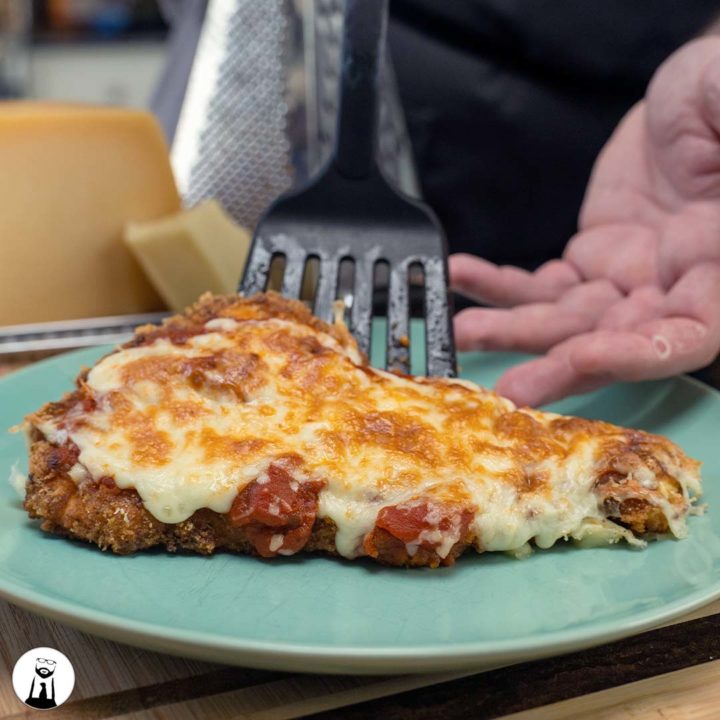 Chicken Parmesan on green plate - Black Tie Kitchen