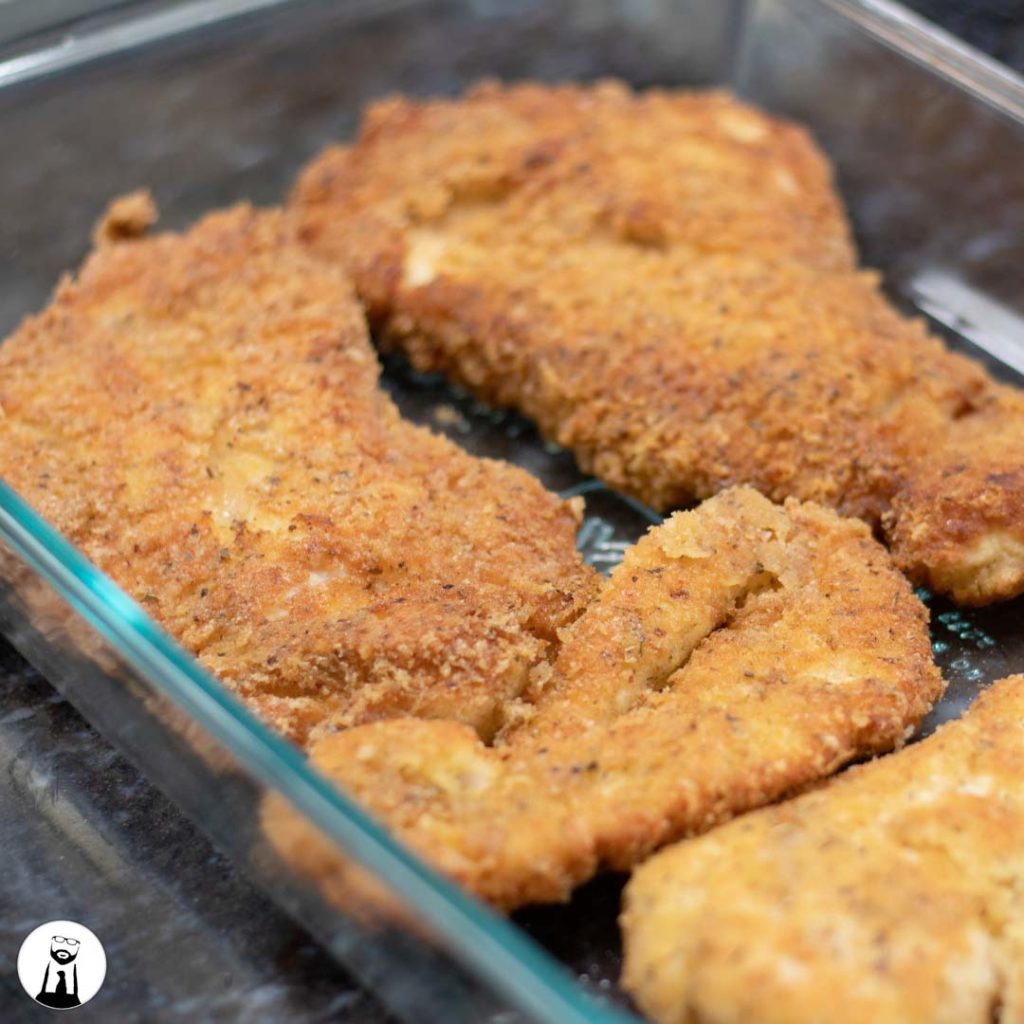 breaded and fried chicken in casserole dish - Black Tie Kitchen