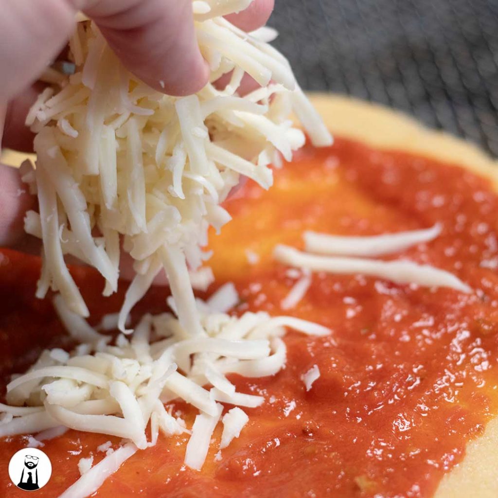 Adding cheese to pizza crust - Black Tie Kitchen
